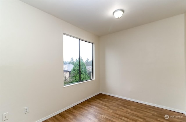 spare room with hardwood / wood-style floors