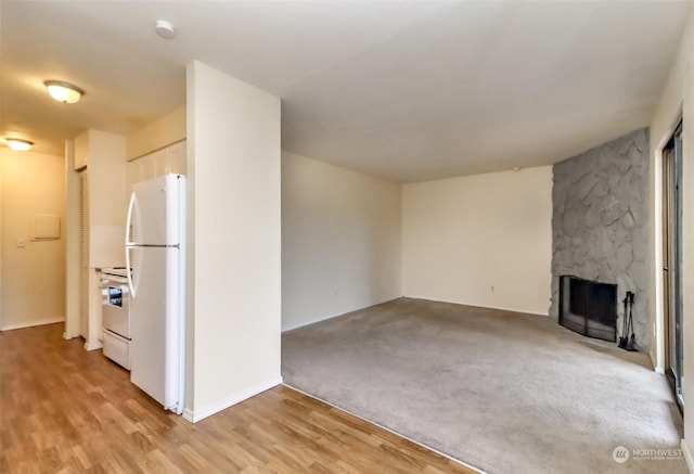 unfurnished living room with a fireplace and light hardwood / wood-style flooring