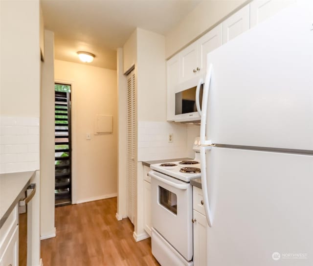 kitchen featuring white cabinetry, white appliances, light hardwood / wood-style flooring, and tasteful backsplash