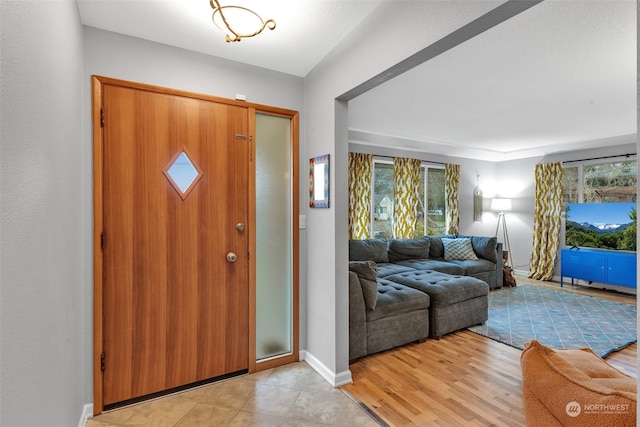 foyer featuring a healthy amount of sunlight and light hardwood / wood-style floors