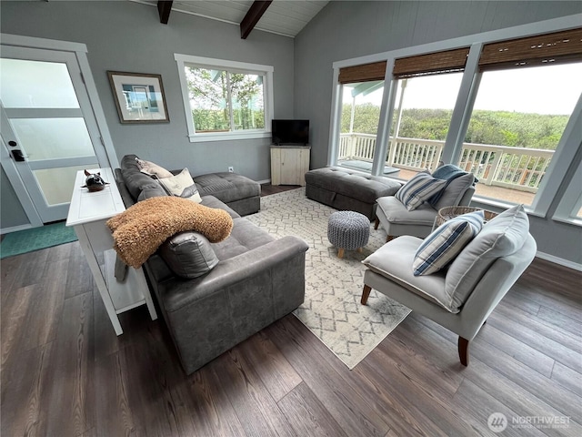 living area with vaulted ceiling with beams, baseboards, and wood finished floors