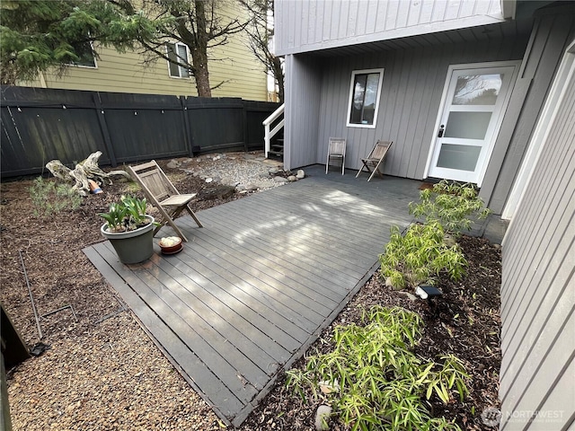 wooden deck with a fenced backyard