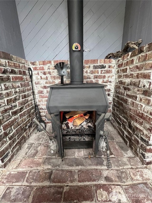 details featuring a wood stove and wooden walls