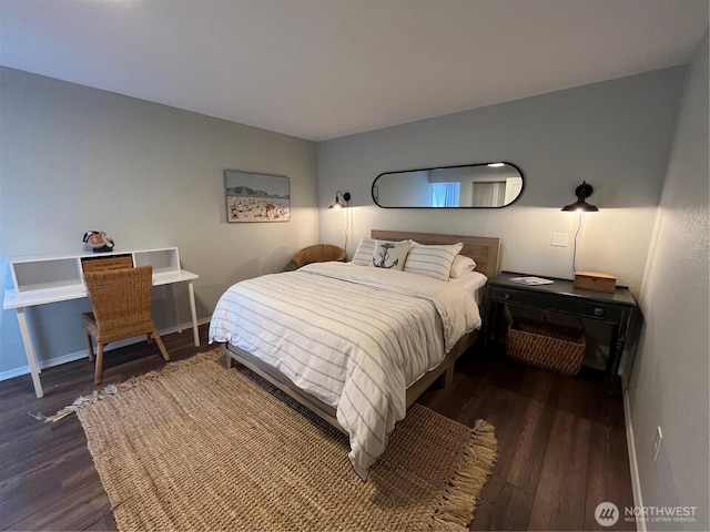 bedroom featuring wood finished floors and baseboards