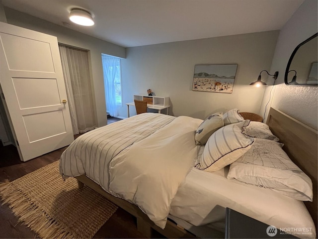 bedroom with dark wood-style flooring