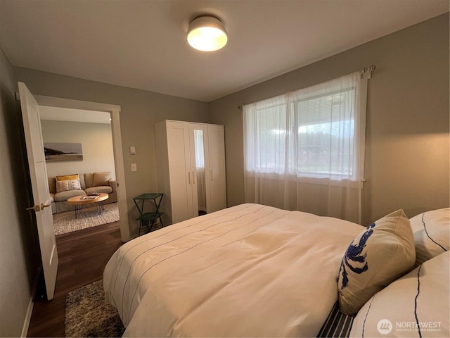 bedroom with dark wood-type flooring