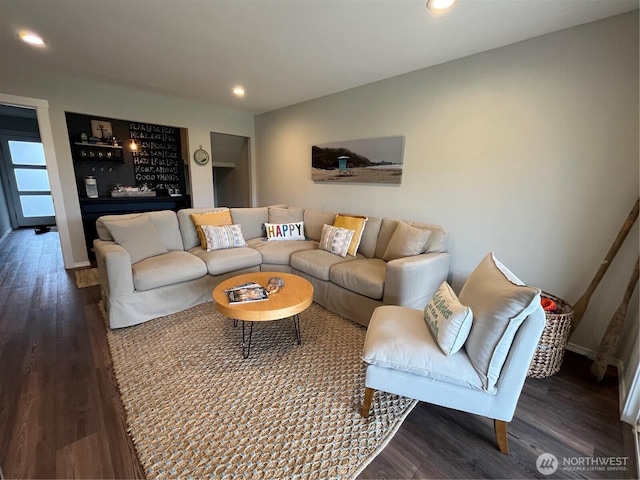 living room with baseboards, wood finished floors, and recessed lighting