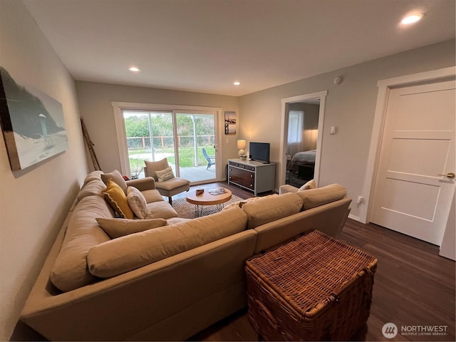 living area with dark wood-type flooring and recessed lighting