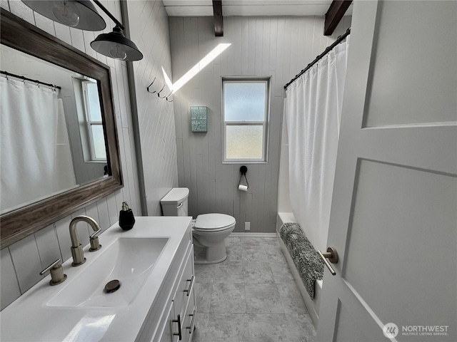 373 Sand Dune Ave NW, Ocean Shores, WA 98569 - full bath featuring toilet, vanity, wood walls, beamed ceiling, and shower / tub combo with curtain