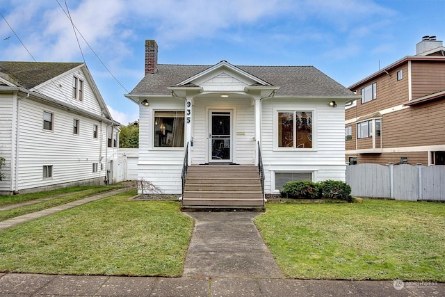 bungalow-style home with a front yard