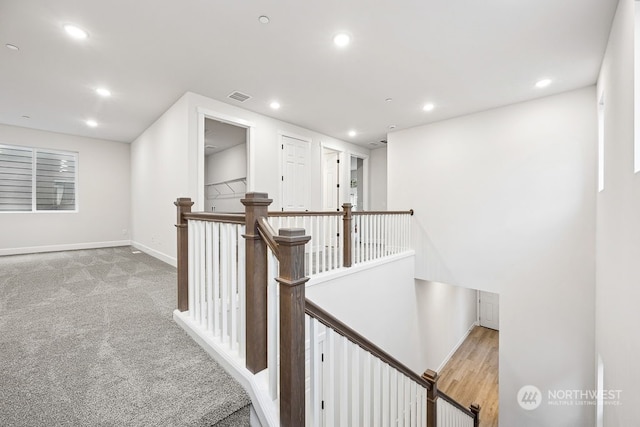 corridor with light colored carpet