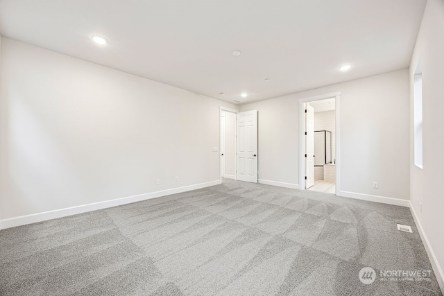 unfurnished room with light colored carpet