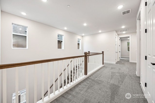 hallway featuring light carpet