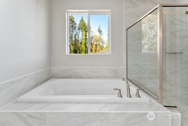 bathroom featuring separate shower and tub