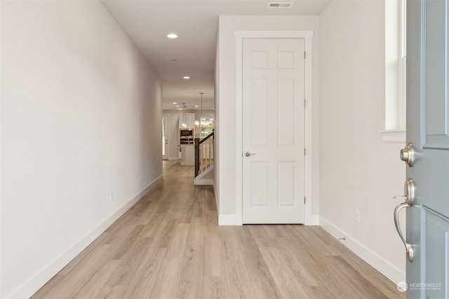 hall with light wood-type flooring