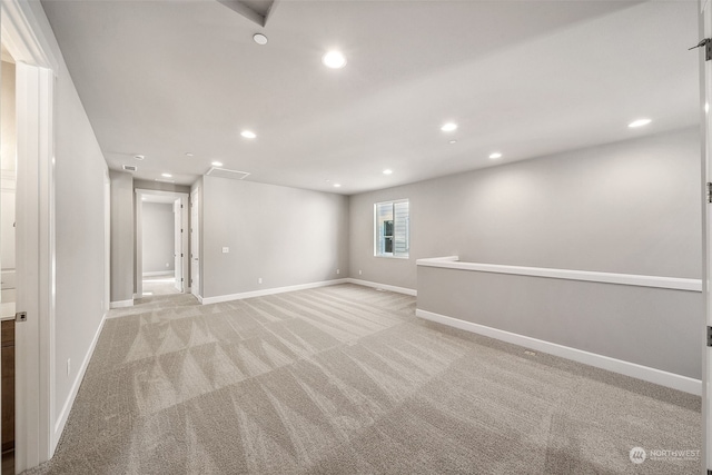 basement featuring light colored carpet