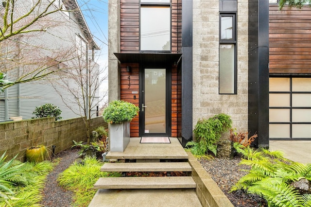 entrance to property featuring fence