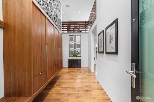 hallway with light hardwood / wood-style floors