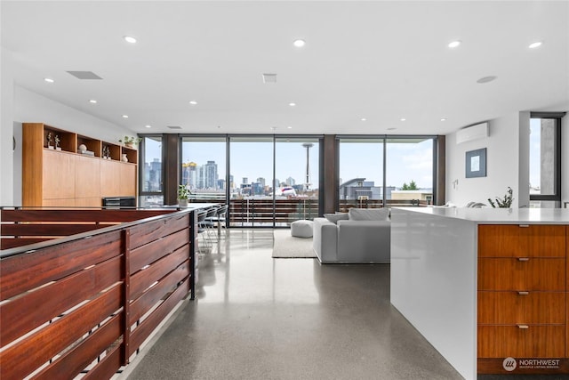 kitchen featuring a wall of windows and a wall unit AC