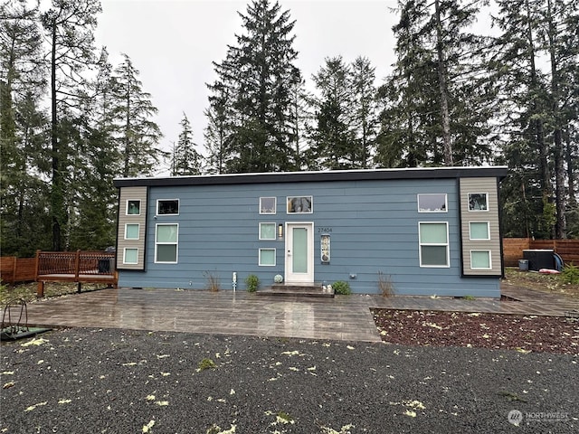 view of front of home with a wooden deck and central AC unit