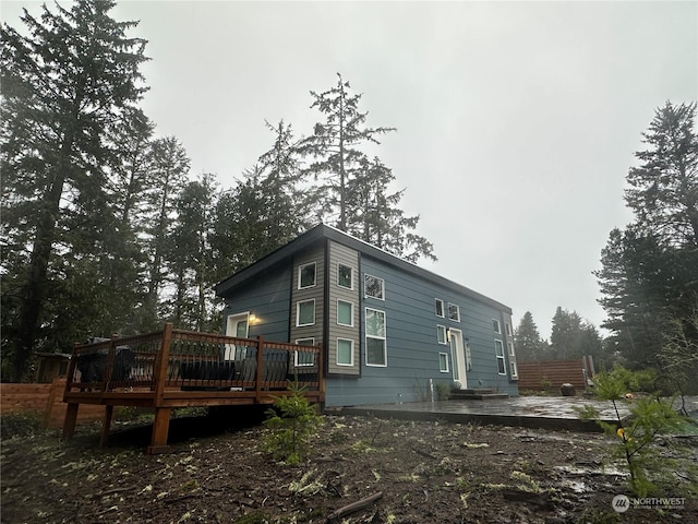 rear view of property featuring a deck