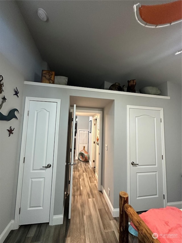 interior space with hardwood / wood-style floors and lofted ceiling