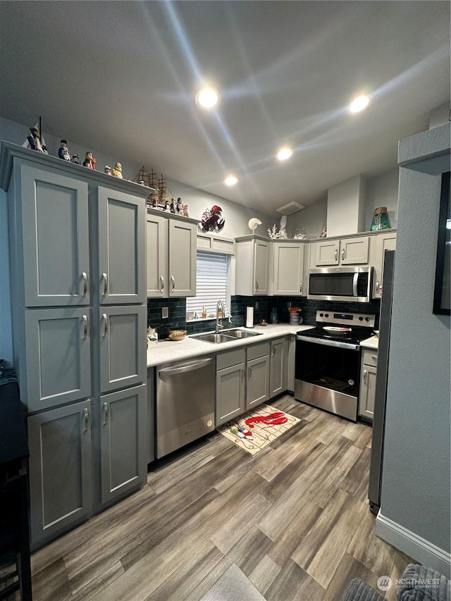 kitchen with gray cabinets, sink, and appliances with stainless steel finishes