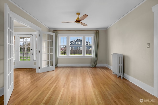 spare room with light hardwood / wood-style floors, ceiling fan, french doors, crown molding, and radiator heating unit