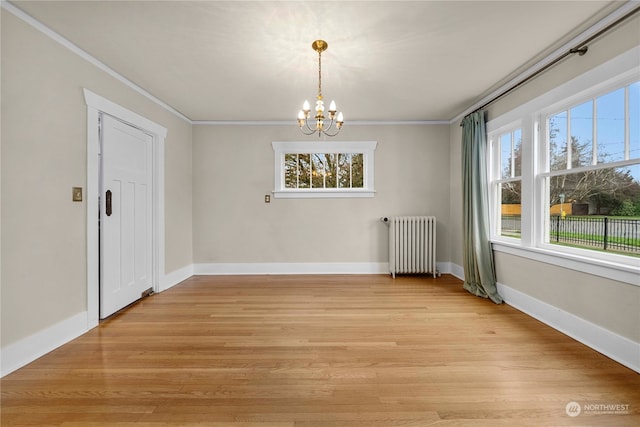 unfurnished dining area with light hardwood / wood-style flooring, radiator heating unit, a chandelier, and ornamental molding