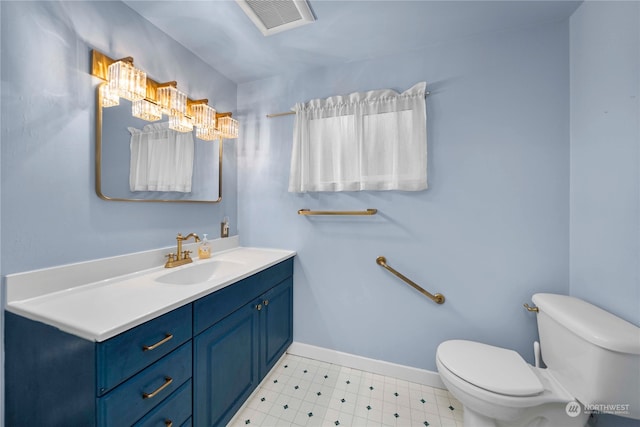 bathroom with toilet and vanity