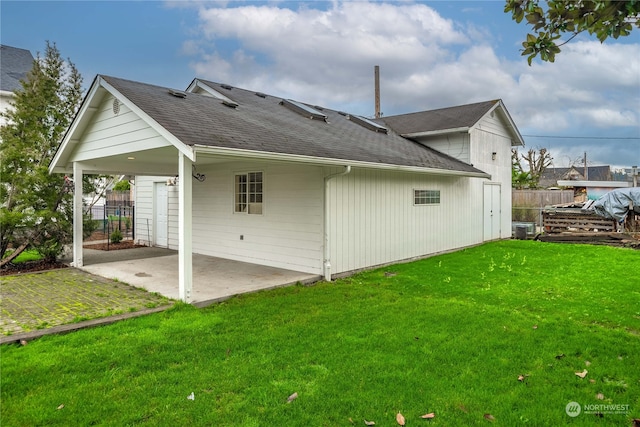 back of house featuring a lawn, cooling unit, and a patio area