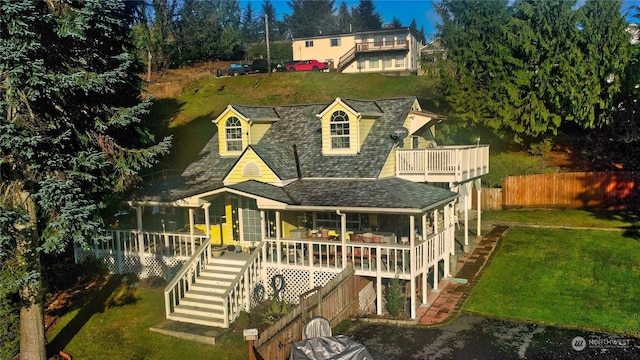 back of house featuring a deck and a yard