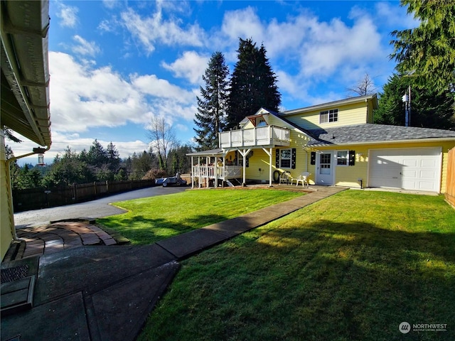 exterior space with a balcony, a garage, and a front lawn