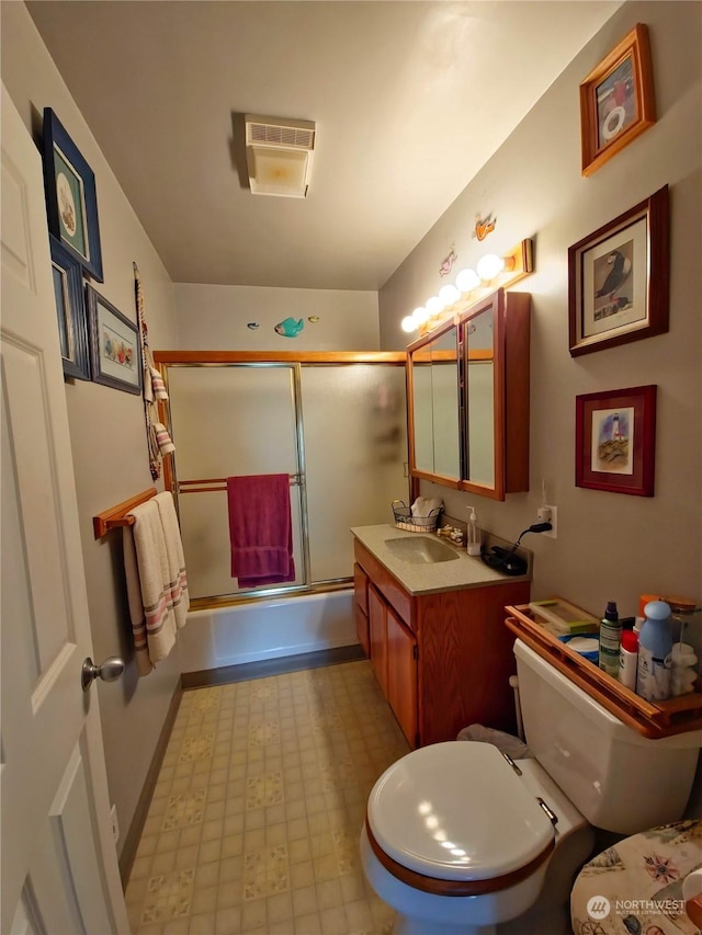 full bathroom with vanity, toilet, and enclosed tub / shower combo