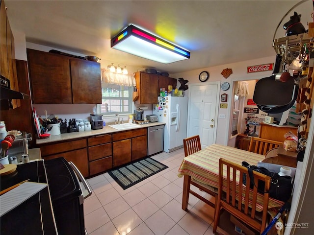 kitchen featuring dishwasher, sink, white fridge with ice dispenser, light tile patterned flooring, and range