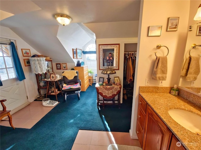 bathroom with vanity, tile patterned floors, and lofted ceiling