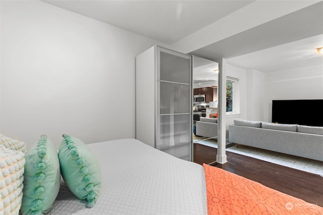 bedroom with dark wood-type flooring