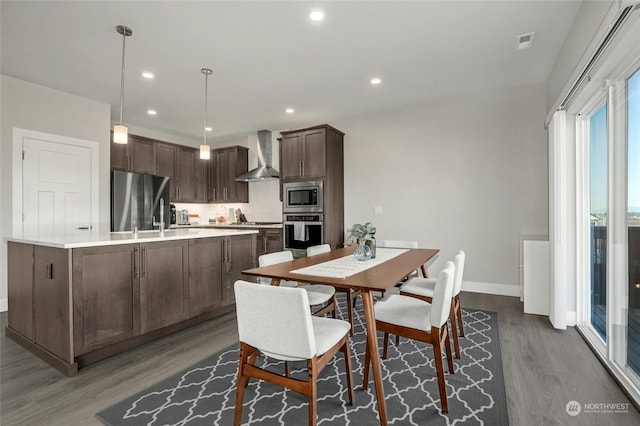 dining area featuring hardwood / wood-style floors and sink