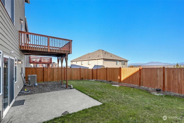 view of yard featuring a mountain view, central air condition unit, and a patio