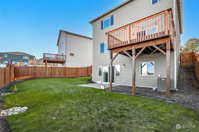 back of property featuring a yard and a deck