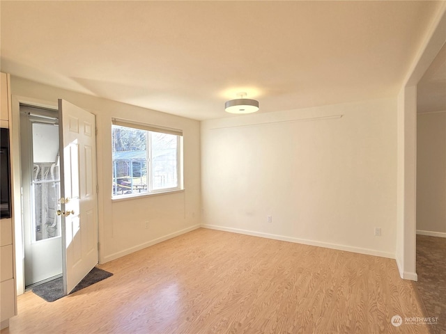 spare room with light hardwood / wood-style floors