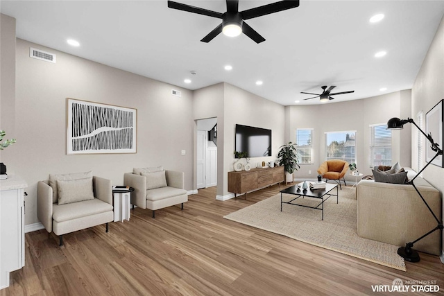 living room featuring ceiling fan and wood-type flooring