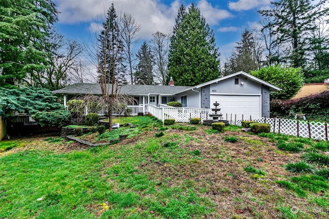 single story home featuring covered porch, a garage, and a front lawn