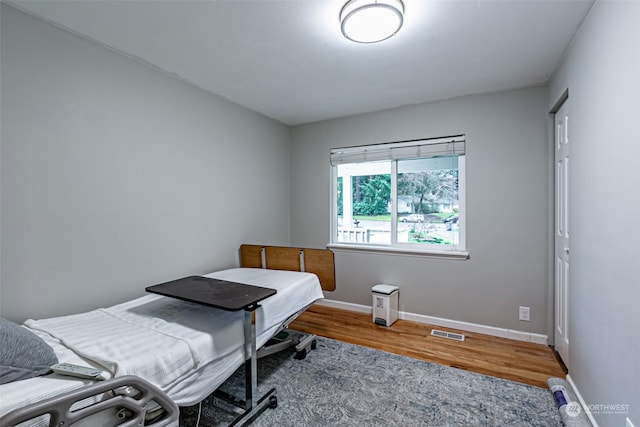 bedroom with hardwood / wood-style floors