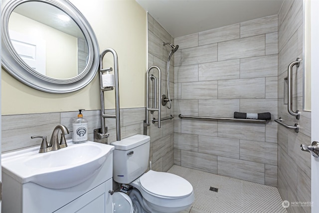 bathroom featuring vanity, toilet, tile walls, and a tile shower