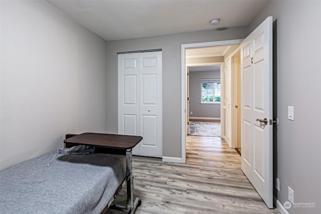 bedroom with a closet and light wood-type flooring