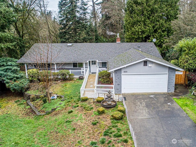 ranch-style home with a garage and covered porch