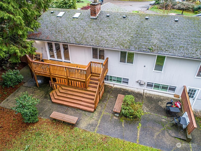 rear view of property with a patio area and a wooden deck