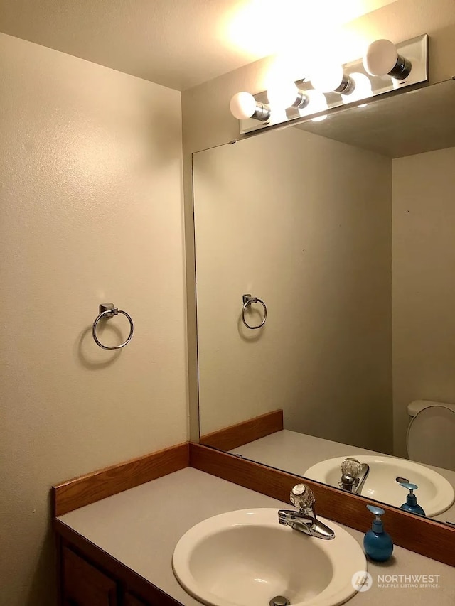 bathroom featuring toilet and vanity