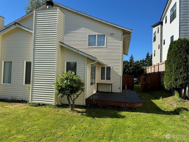 back of house with a yard and a wooden deck